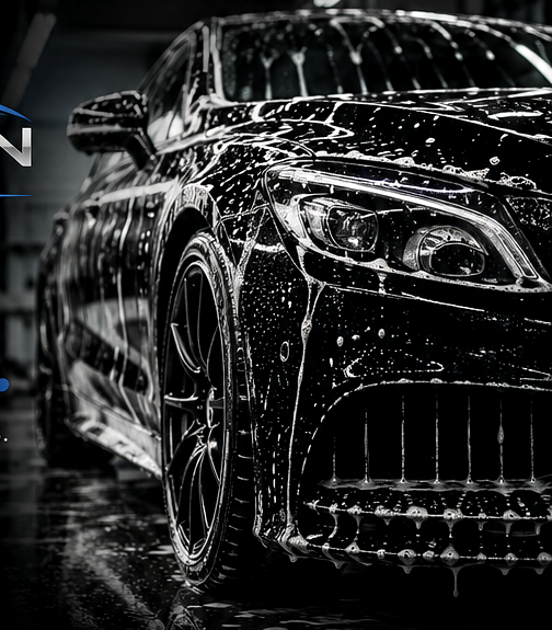 Black luxury car being washed with foam and water